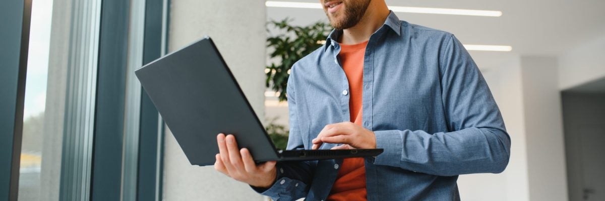 A Freelancer Man Works With A Laptop In A Work Coaching Office - Alliance Contabilidade